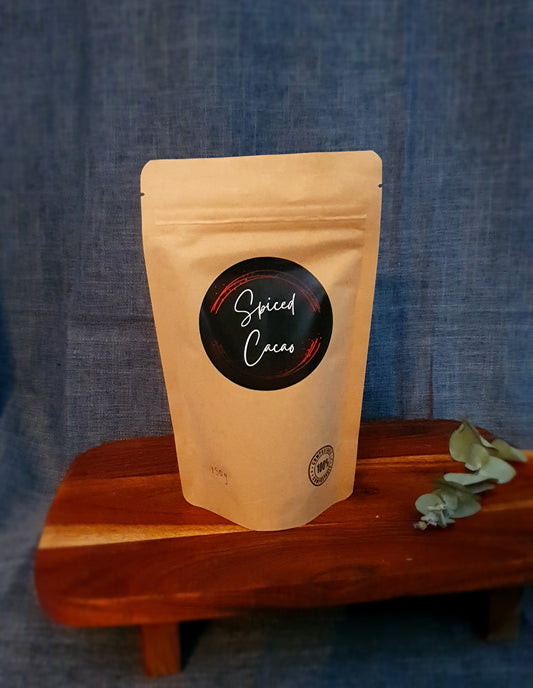 Spiced Cacao elixir bag on display with leaves