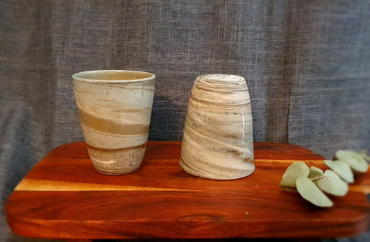 Two handmade mugs on display