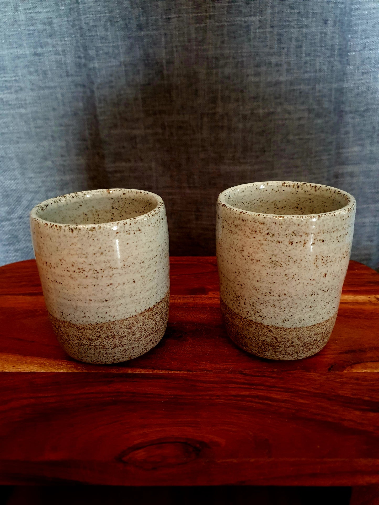 Two medium handmade mugs on display