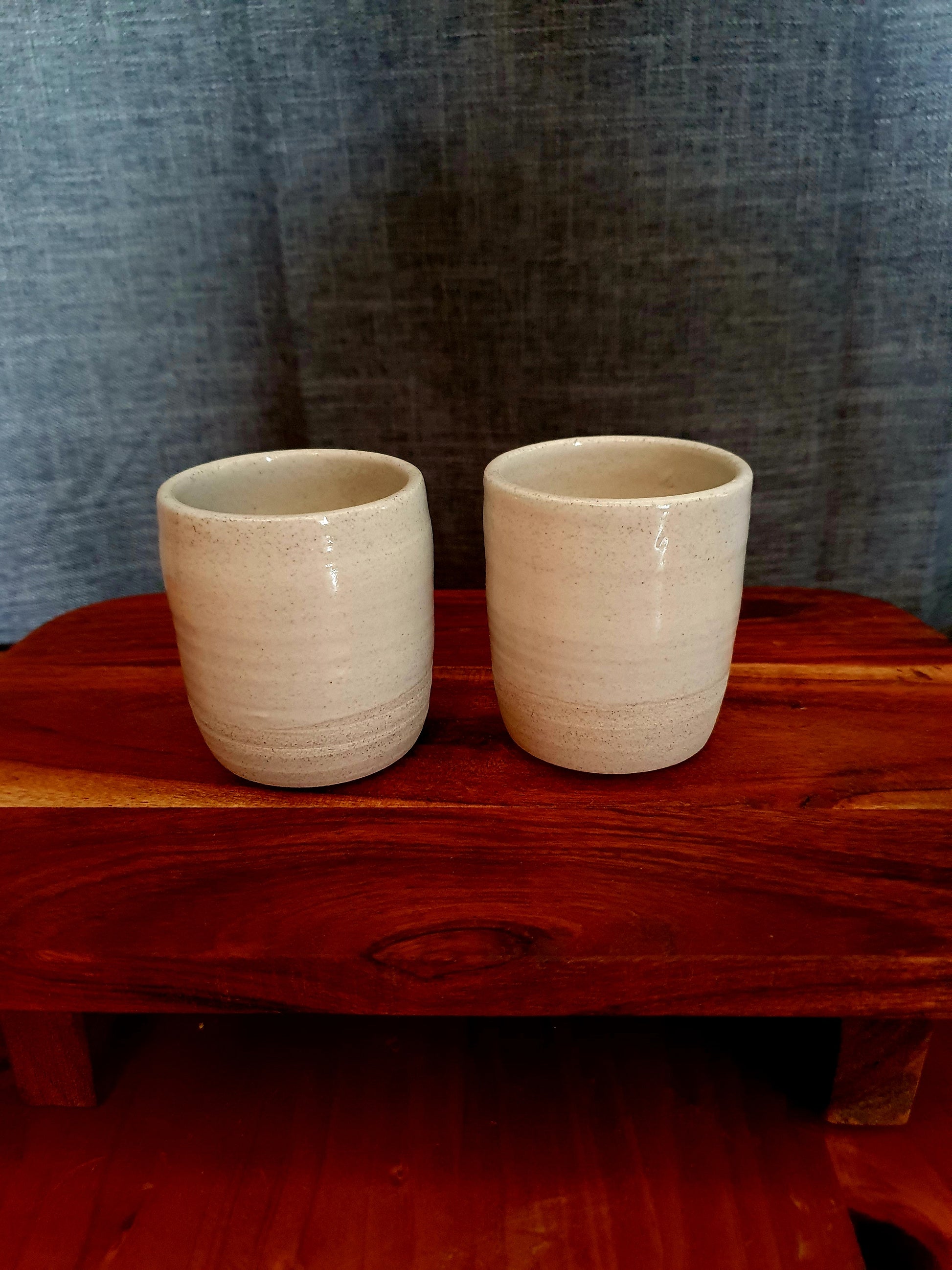 two small handmade mugs on display